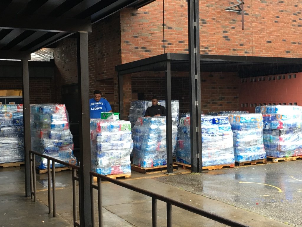 Volunteers unload pallets of bottled water collected during the Central Georgia water drive for families affected by the Flint, Michigan water crisis.